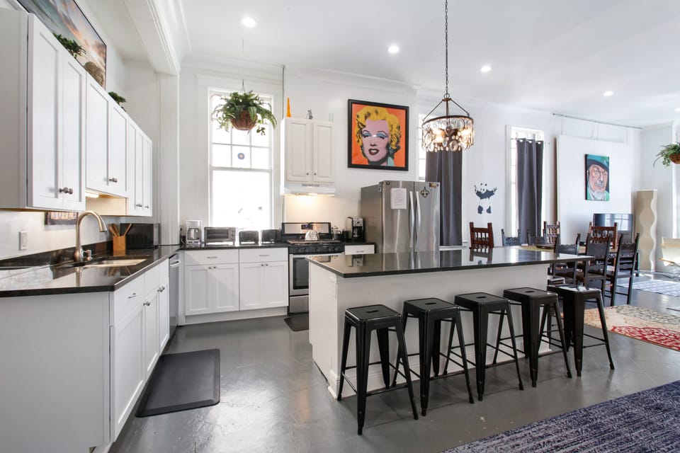 Bright, spacious kitchen with 6-seat island is open to dining and  living areas.