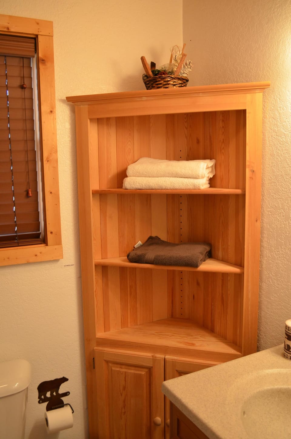 En suite master bathroom with plenty of storage and custom tiled shower