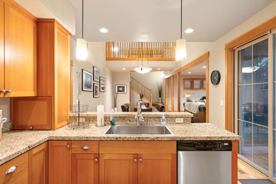 Enjoy cooking and entertaining with this open kitchen design, featuring granite countertops, modern fixtures, and seamless views into the dining and living areas.