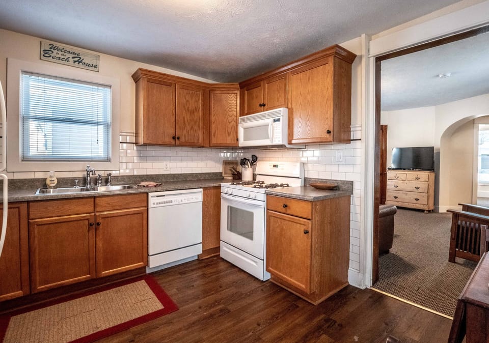 Kitchen with dishwasher, self cleaning gas range and space maker microwave.