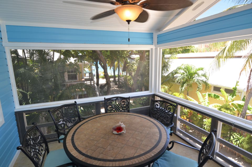 Balcony with bar height patio furniture for unobstructed view of the sea.