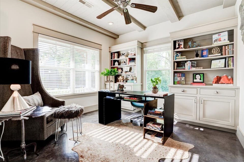 Sunlit private office, full of art and interesting books.