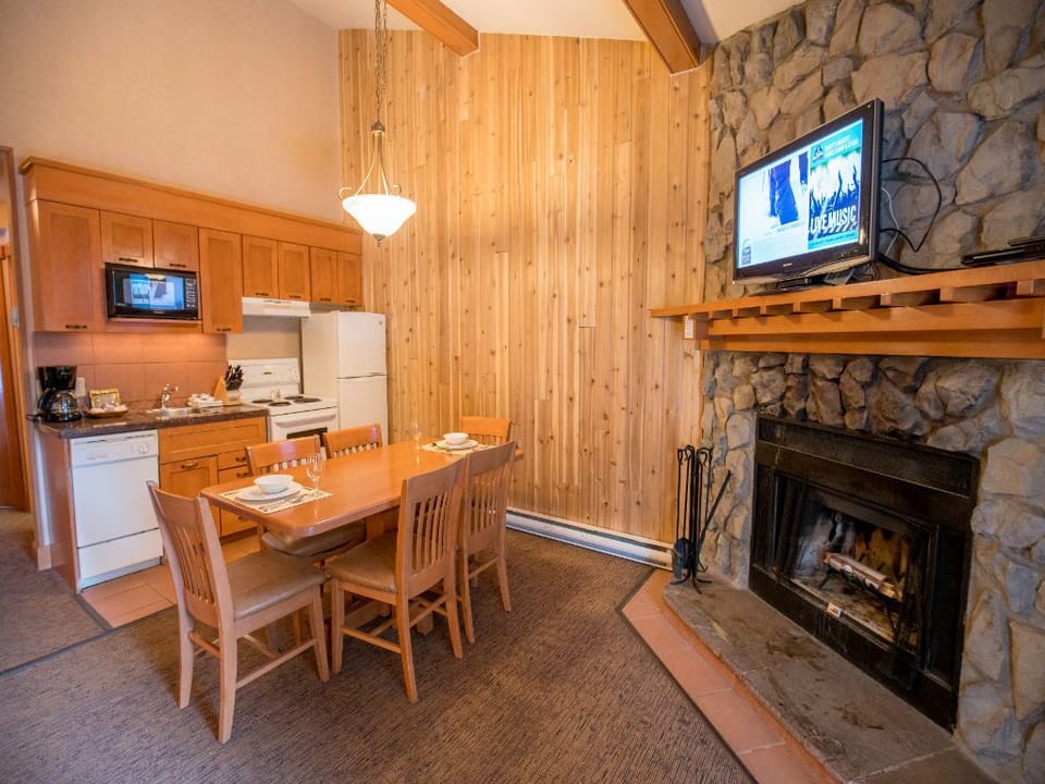 Enjoy meals by the warmth of the fireplace in the inviting resort lounge dining space.