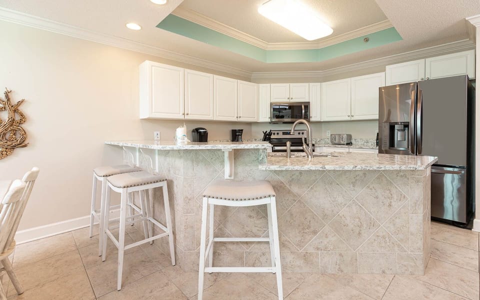 Enjoy casual meals at the breakfast bar, featuring stylish stools and a well-designed kitchen space for your culinary