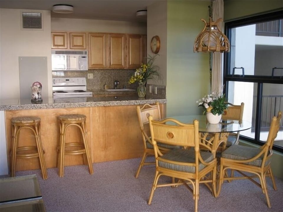 Upgraded kitchen/dining area with granite counter tops and maple cabinets with
