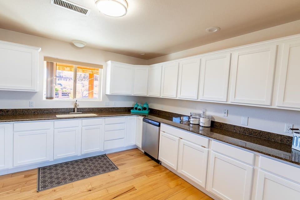 Nice kitchen w/newly painted cabinets filled with amenities to use for your stay