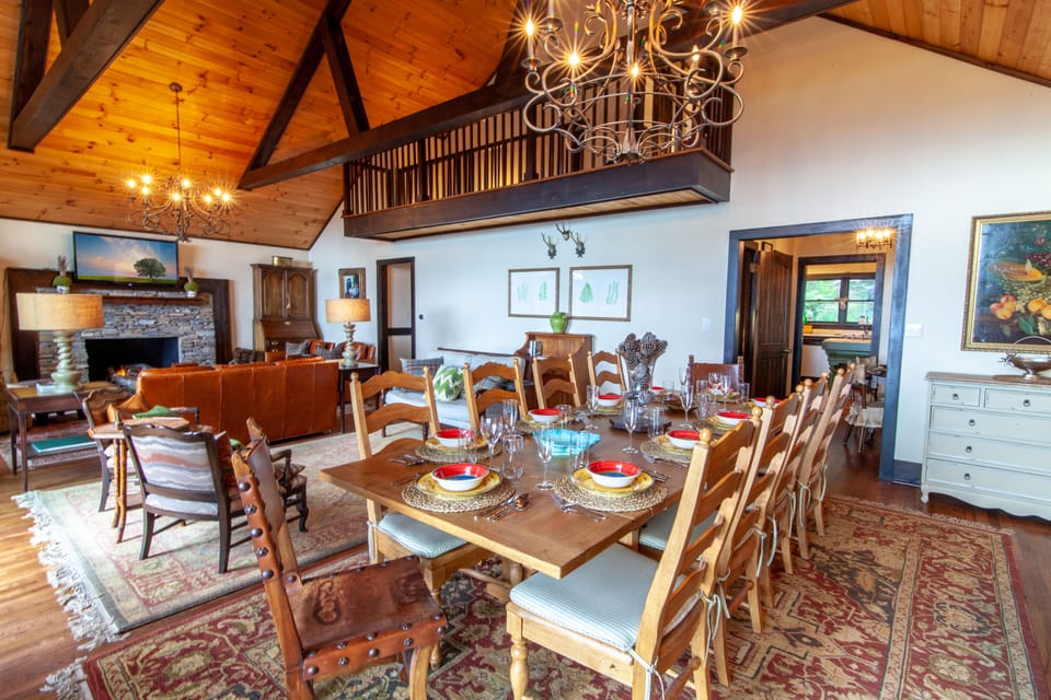Dining Table and Great Room with Hardwood Floors, Vaulted Ceilings, and Exposed Beams