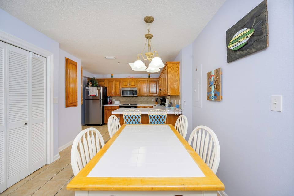 Sunlight bounces off the dining table and breakfast bar where you plan snacks before beach adventures