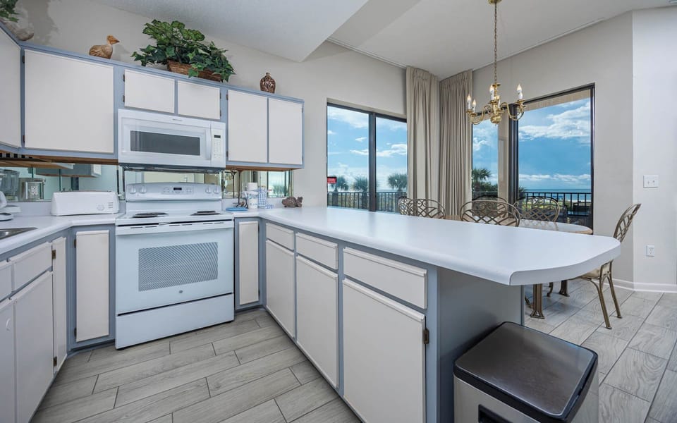 Enjoy cooking in the spacious kitchen with a large breakfast bar, relaxing with views of the beach