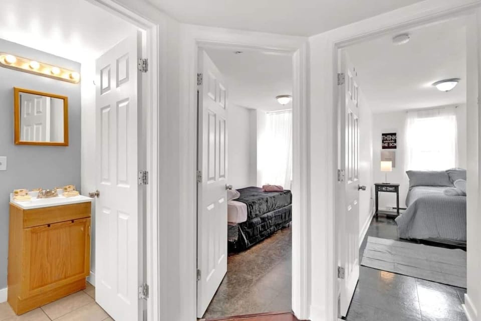 Bedroom entrance from living room showing open layout and modern finishes.