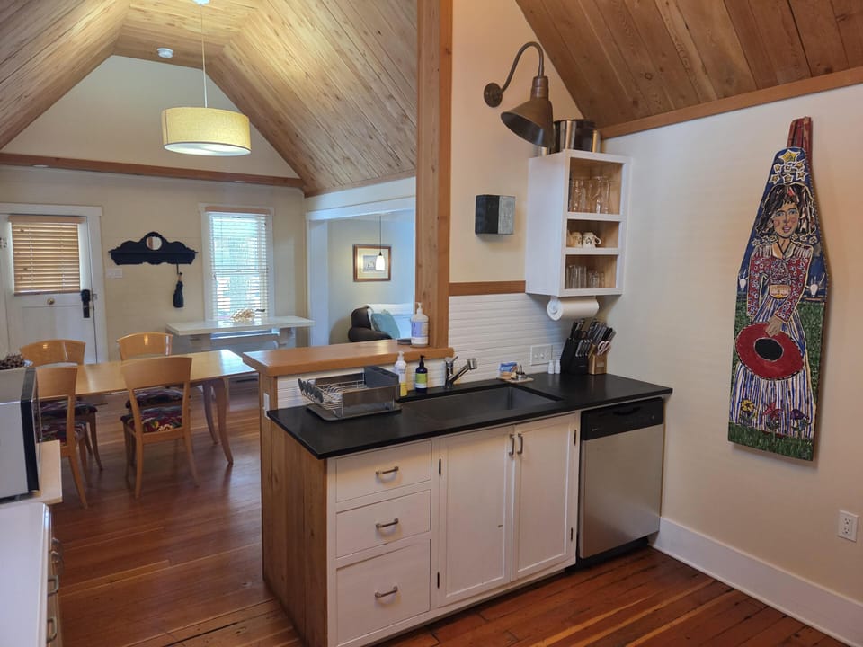Cozy open kitchen and dining area with vaulted ceilings