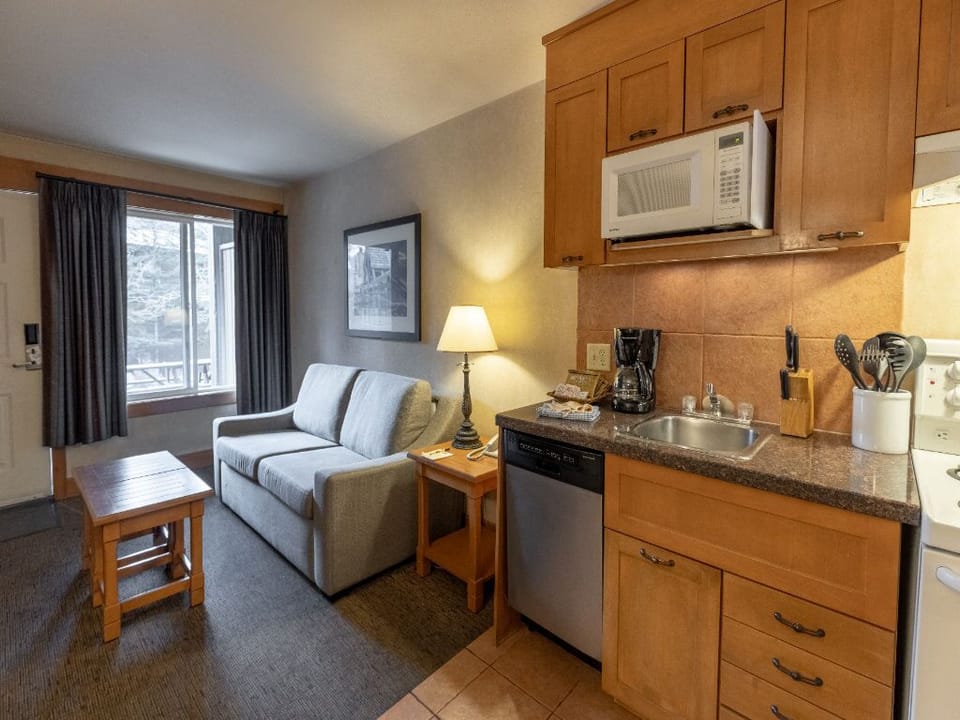  Unwind in this inviting one-bedroom retreat, featuring a cozy living space and a convenient kitchenette that adds to its warm and homely charm.