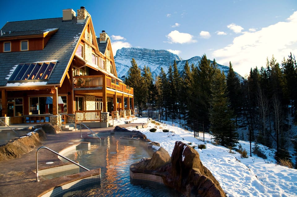 Soak in the warmth of a serene mountain retreat, surrounded by snow-covered pines and breathtaking alpine views.