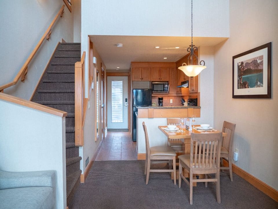 Dine in the open-concept space, seamlessly connecting the kitchen and loft for a spacious and comfortable experience.