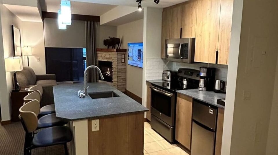 Sleek open kitchen with a spacious island and stylish lighting, perfect for cooking and entertaining.