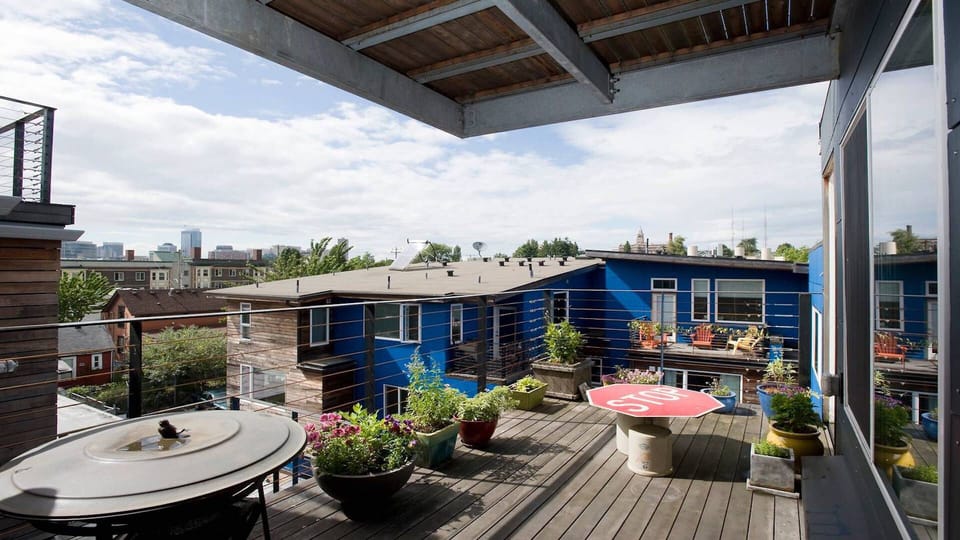 View north from 4th floor deck, featuring herb garden &  charcoal grill/ fireplace.