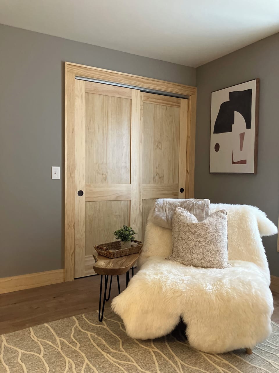 Sink into this plush armchair with your morning coffee, surrounded by warm wood and thoughtful touches that make this space truly yours.