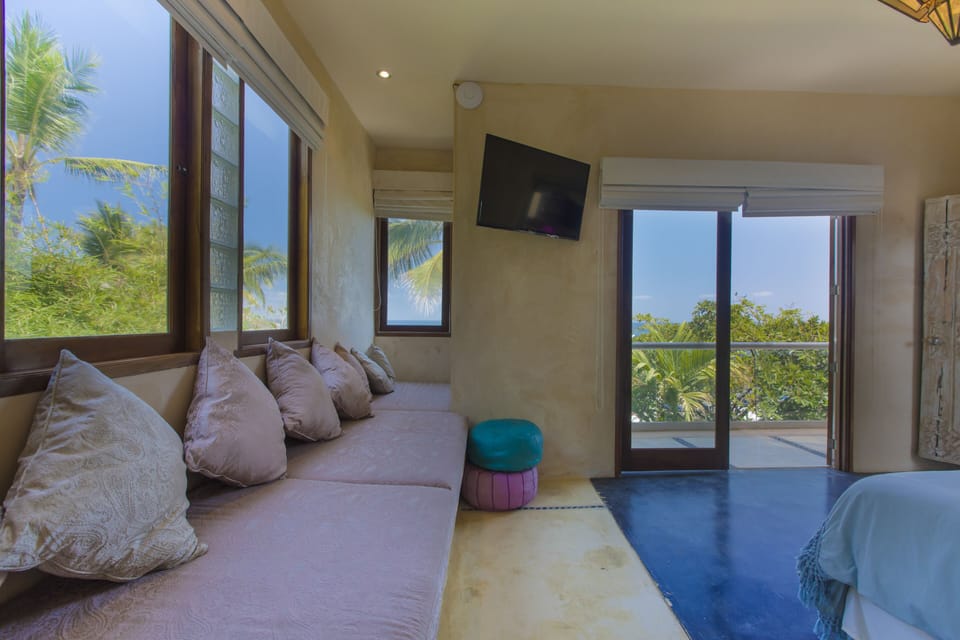 couch bed and terrace overlooking the beach