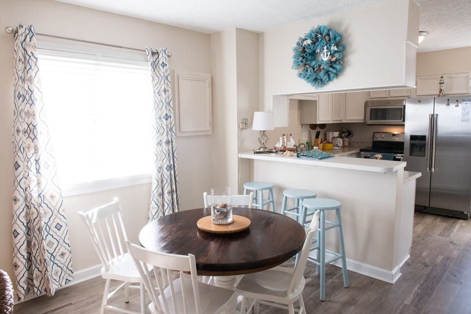 Table for four plus a breakfast bar for three more gives great space to eat.
