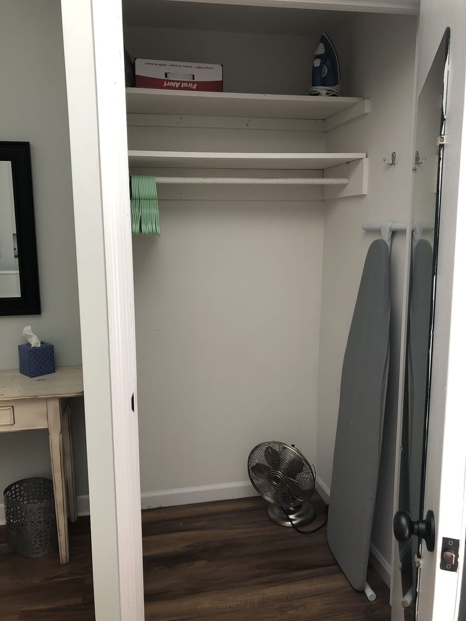 The closet offers plenty of hanging space and storage for your personal items.