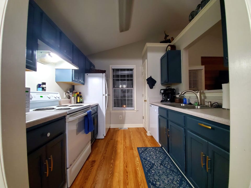 kitchen stocked with all cooking equipment/ plates/ utensils/ cups