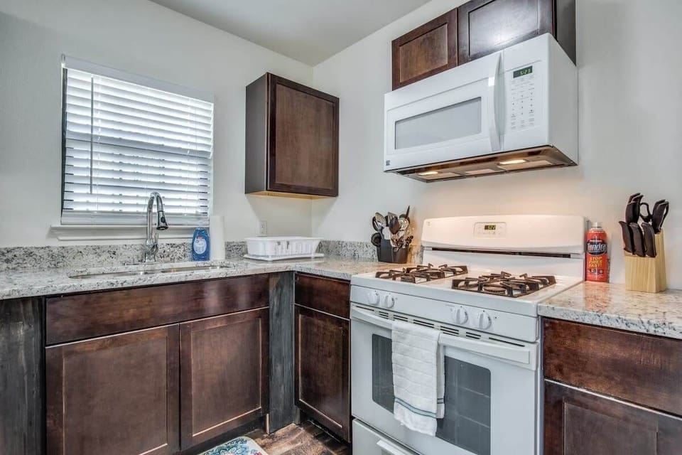 Kitchen with gas stove/oven, microwave, refrigerator to the right – there’s no dishwasher so we hope you don’t mind doing those few dishes you use by hand