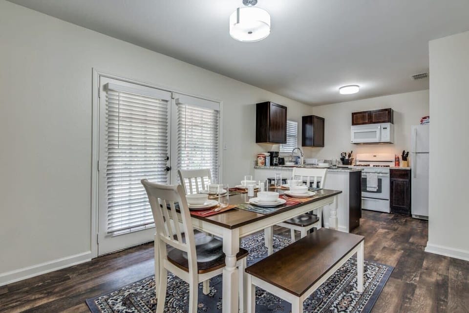French doors lead out to the back yard/patio, you'll find the washer/dryer in the utility room on the left side of this patio