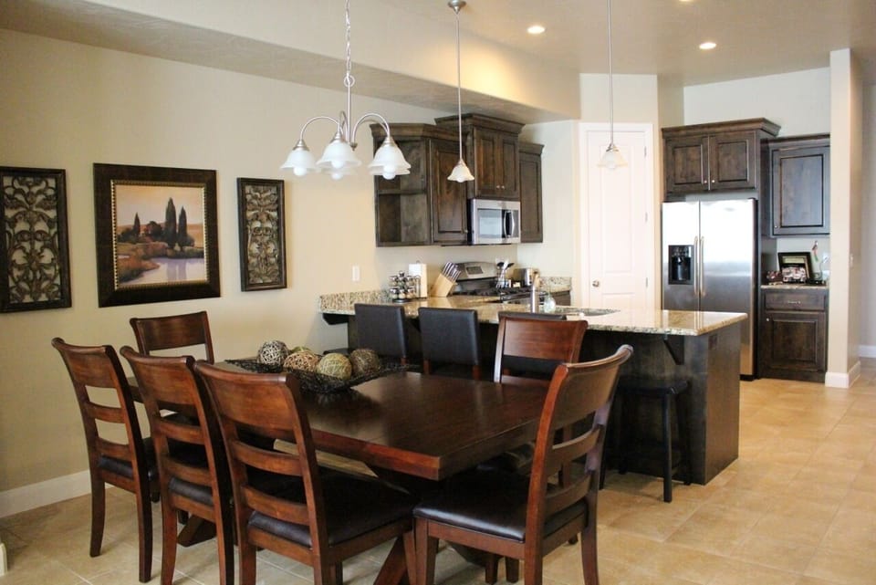seating area with large table, bar stools, seating for 13, large, open kitchen