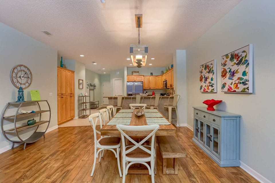 Kitchen Opens into the Dining Area Featuring a Large Table with Seating for 8