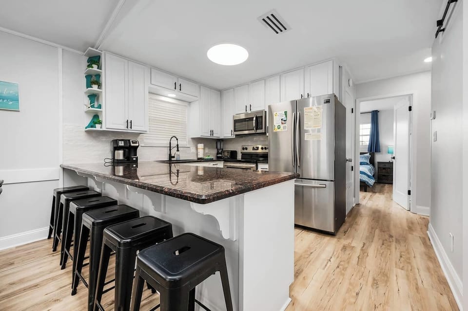 Great kitchen overlooking the dining/livingroom with bar seating
