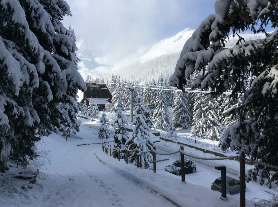 down drive to on-street parking and across to gondola