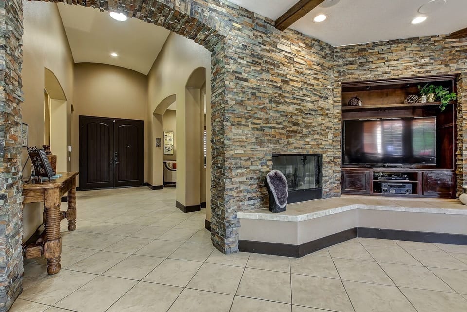 Custom stone walls and entryway with 10 ft ceilings throughout the house.