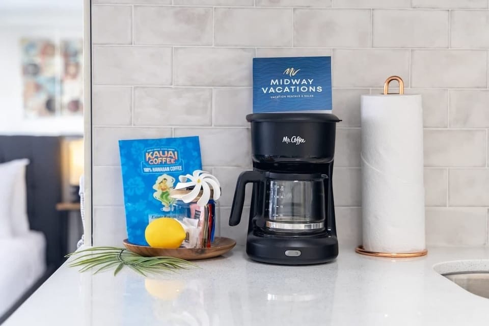 Start your day right with a fresh cup of coffee from the provided coffee maker, featuring complimentary coffee.