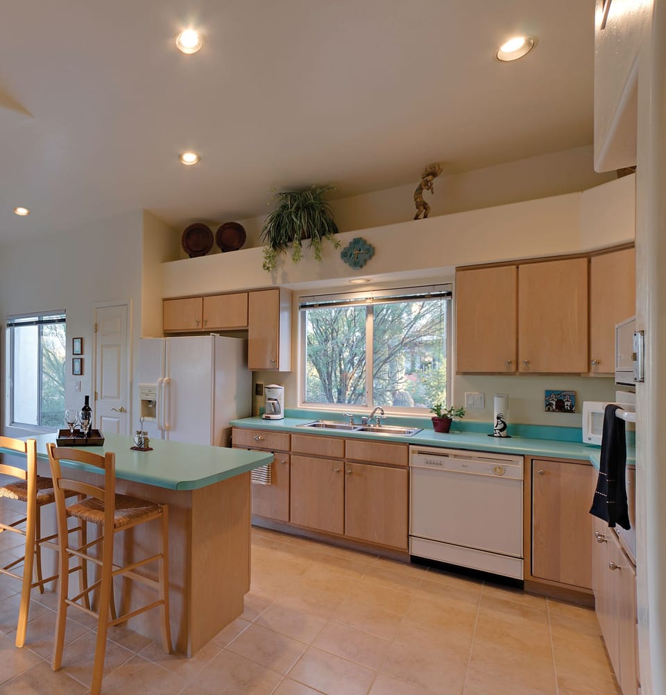 Light and airy kitchen with island. Ceramic tile flooring in all but 2 bedroom