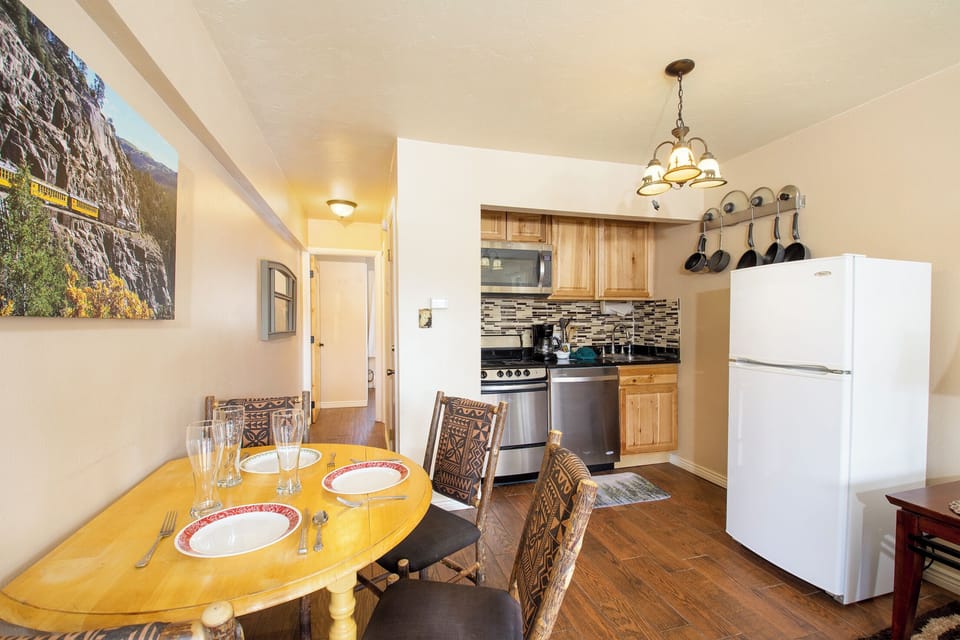 Your cozy kitchen-dining space features warm wood cabinets, modern appliances, and a charming breakfast nook where you'll enjoy morning coffee together.