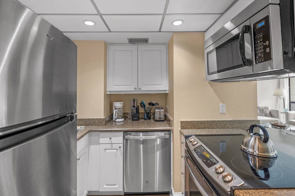 The kitchen has stainless steel appliances.