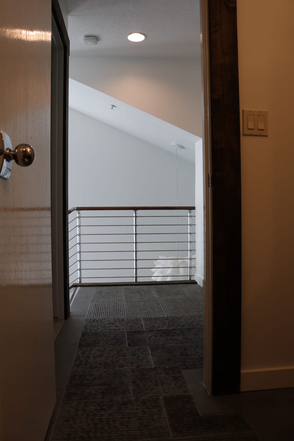 View from the 2nd Suite bathroom to entry below and custom stainless railing.