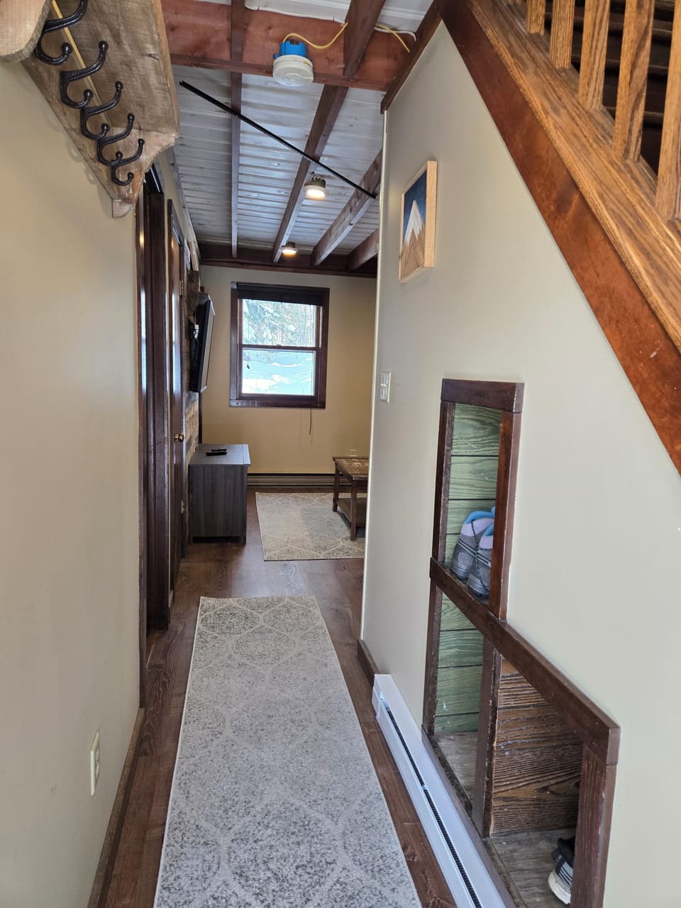 Entry way with boot cubies, and coat hooks and closet. 