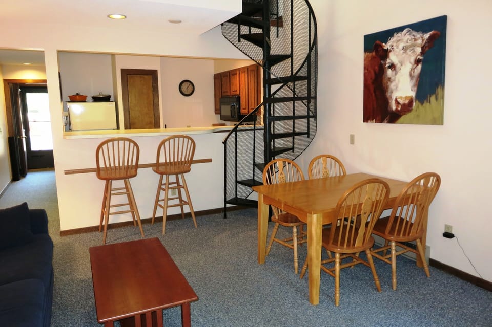 Bar seating beside kitchen. Table includes extra leaf and chairs to seat 8.
