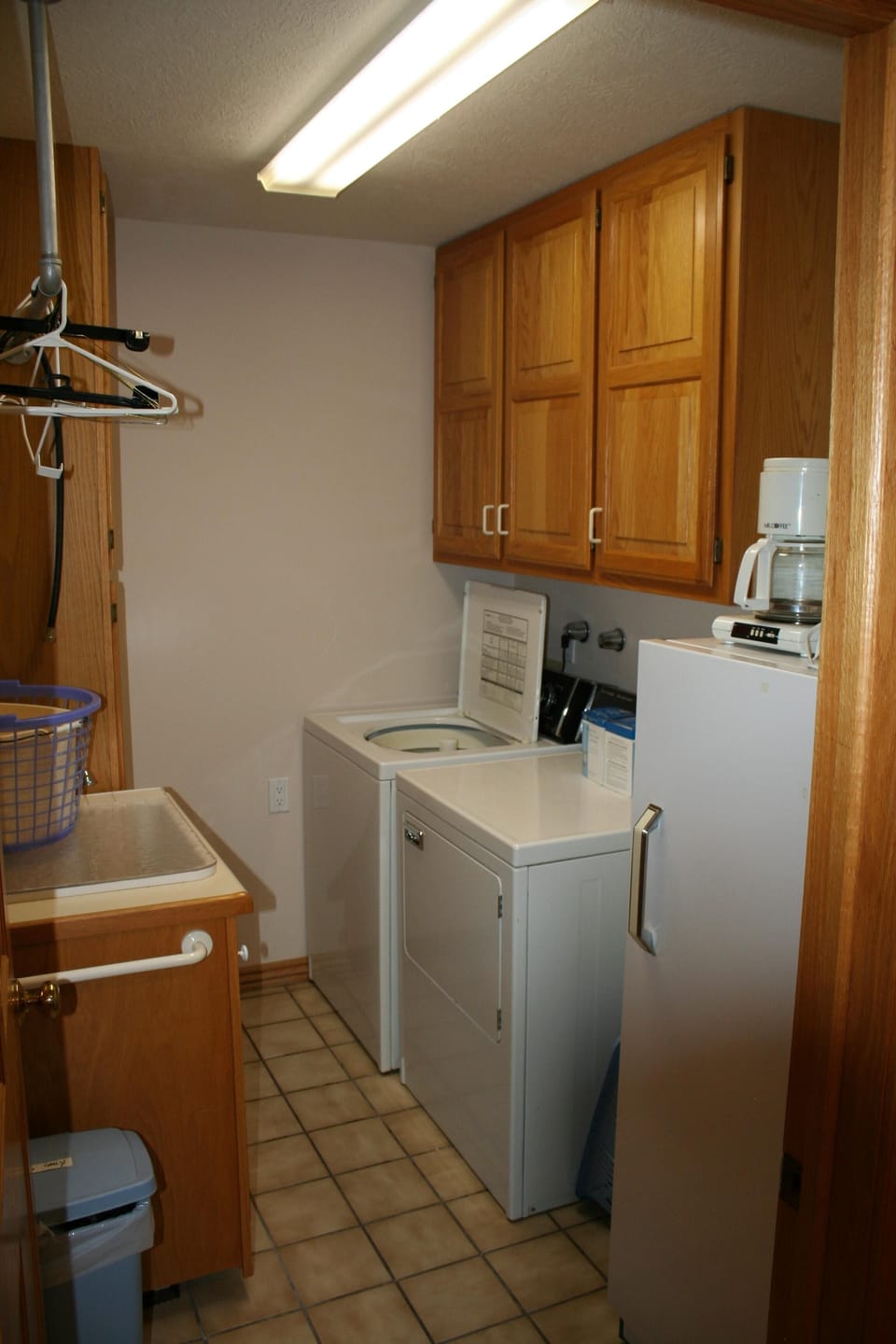 Deep-freeze and full sized washer and dryer in laundry room off of kitchen.