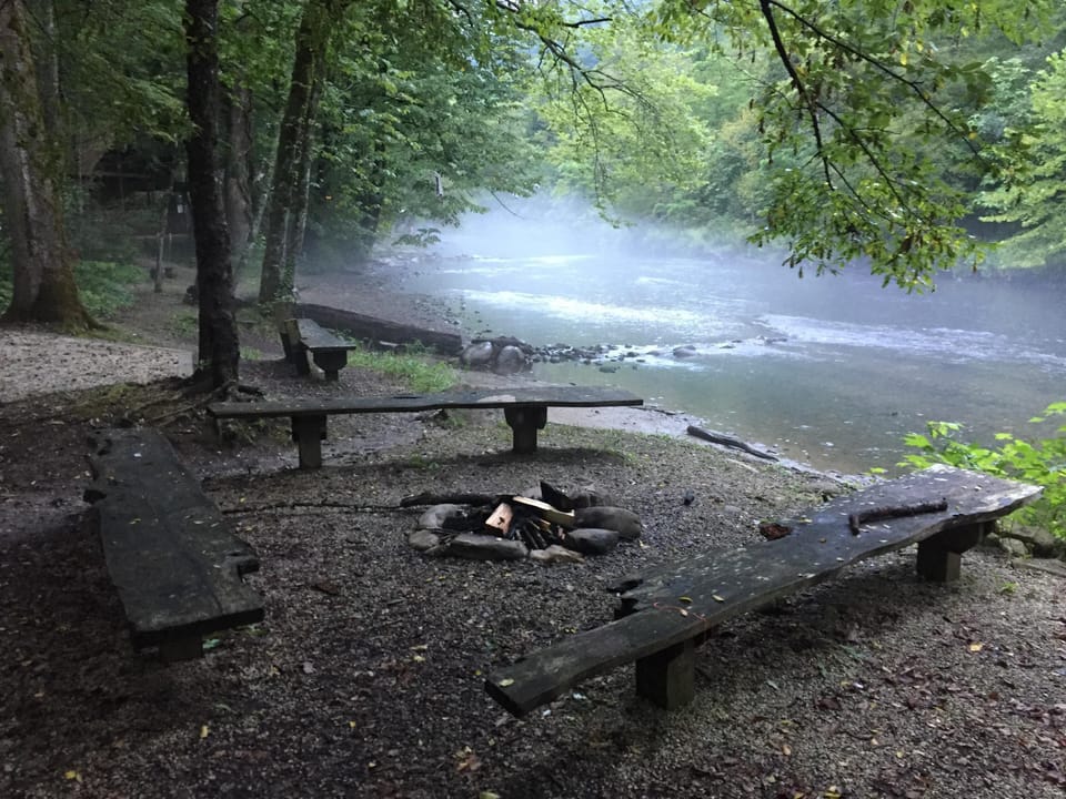 Fire pit and benches beside grill area on beach