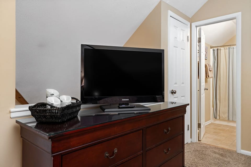 Loft bedroom TV w/Roku; closed door is the game cave, open door is the bathroom
