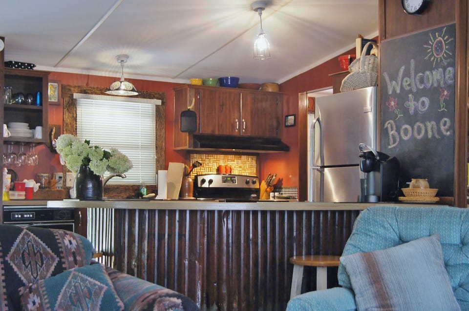 View toward kitchen with amenities like wine glass rack, cork thingy and sink!
