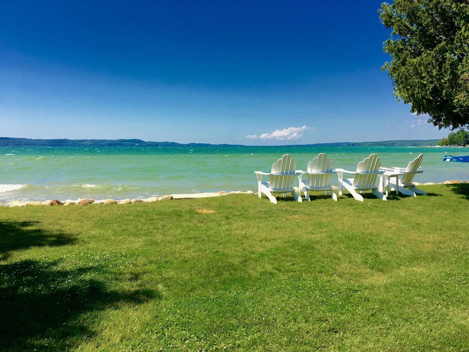 Stunning Torch Lake! This cottage has nearly 200 feet of soft sandy beach