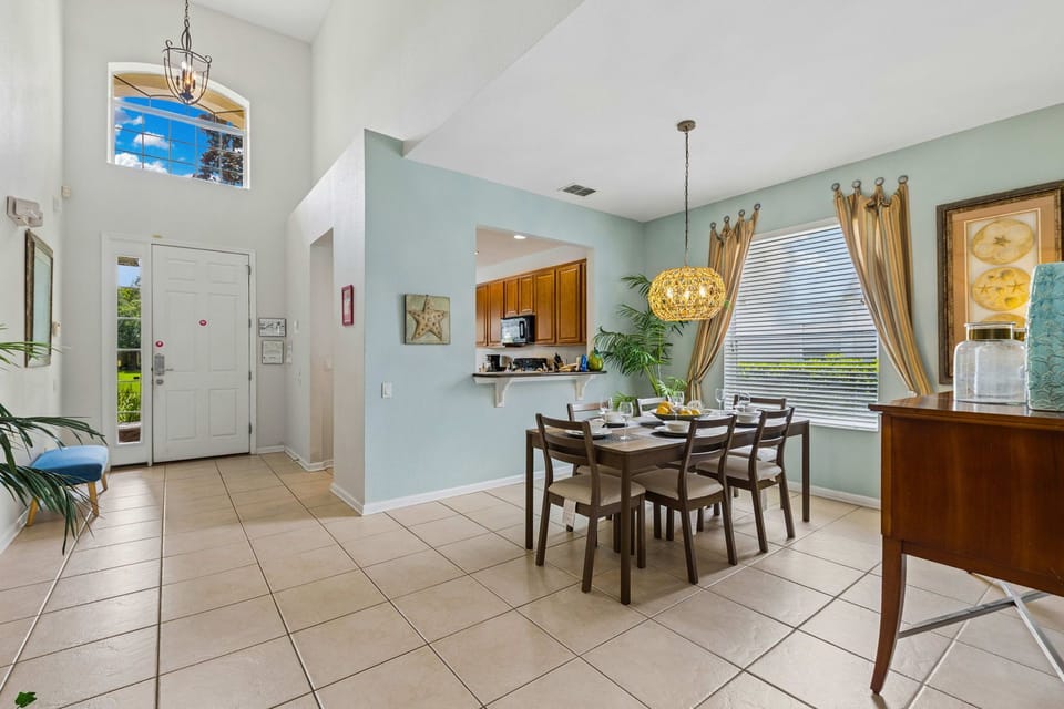 Classy 6 persons dining area of the home in Kissimmee, Florida - Savor the experience of exquisite dining and treasured moments - Smooth incorporation of natural elements, such as plants, for a fresh and vibrant atmosphere