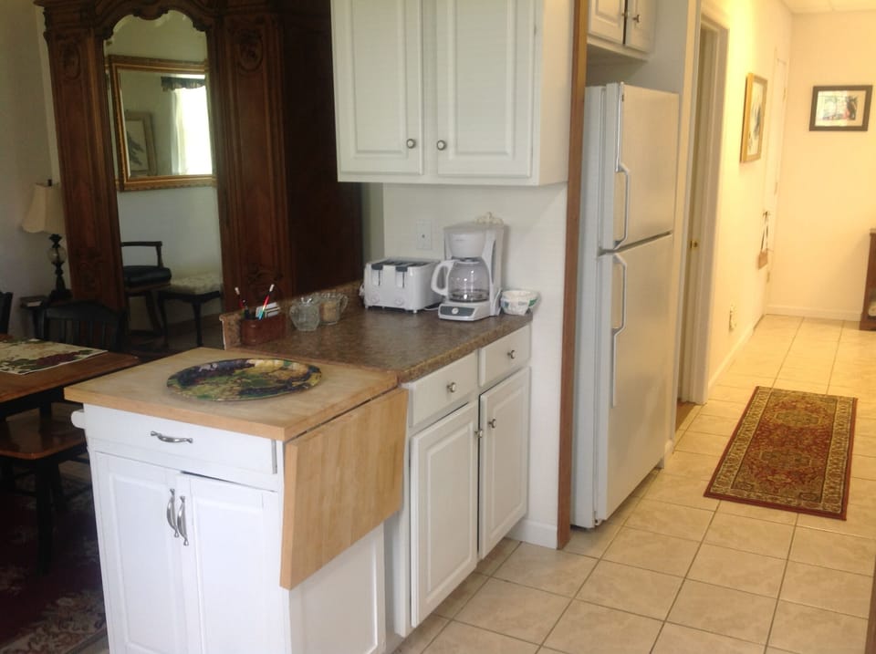 Kitchen with dishes, pots & pans, utensils, full size fridge & freezer