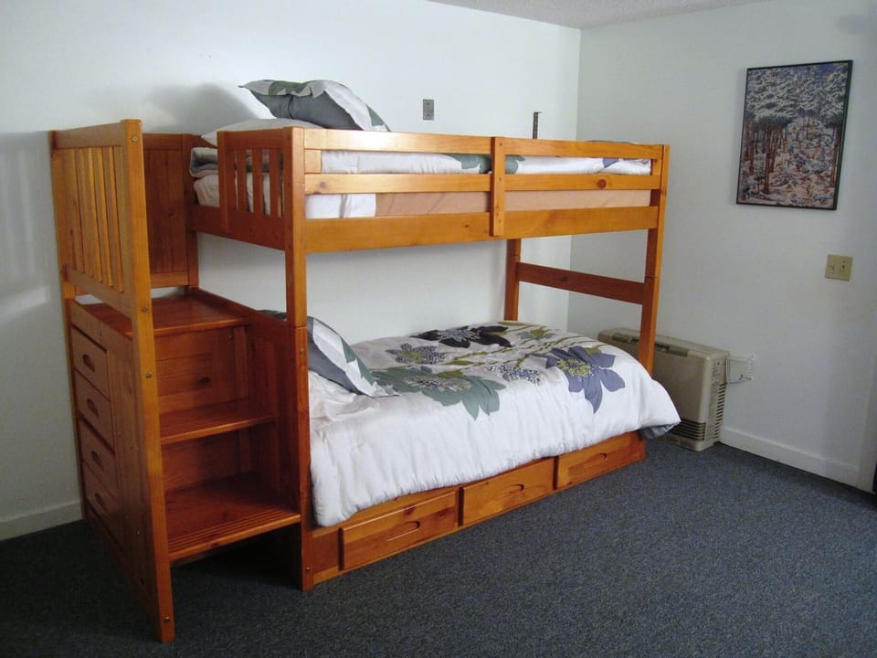 Downstairs bedroom includes sturdy and comfy bunk beds with built-in drawers
