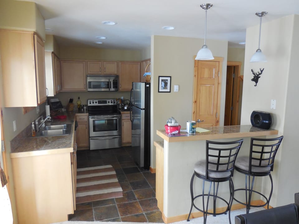 Kitchen on main/second floor. Granite counters and stainless steel appliances.