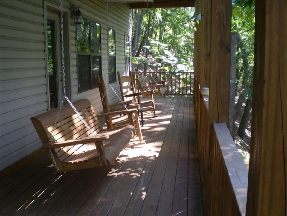The lower deck with rockers, porch swings, and seasonal views.