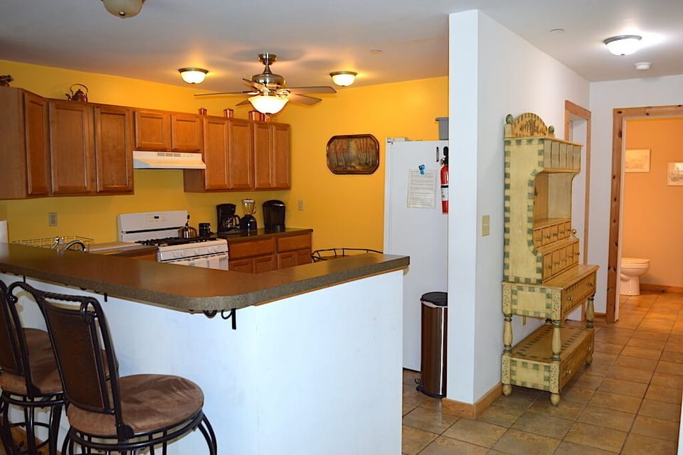 View of East Wing Kitchen and Hall to Half Bath.
